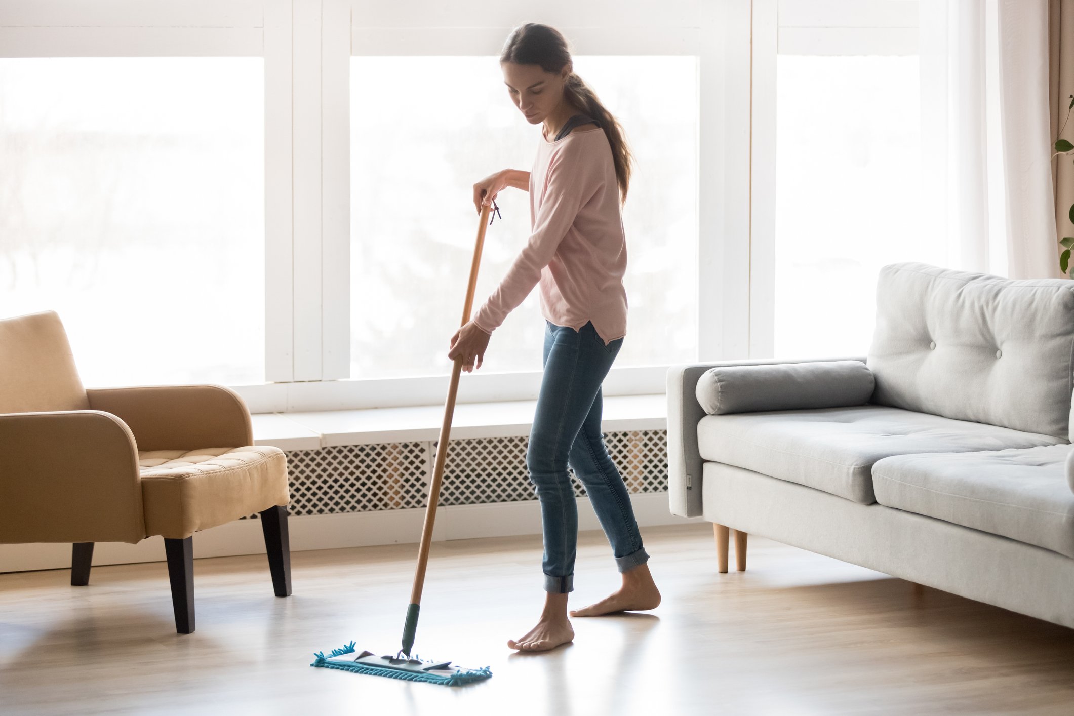 A person sweeps the floor.