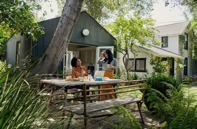 Two people eating in front of a vacation rental