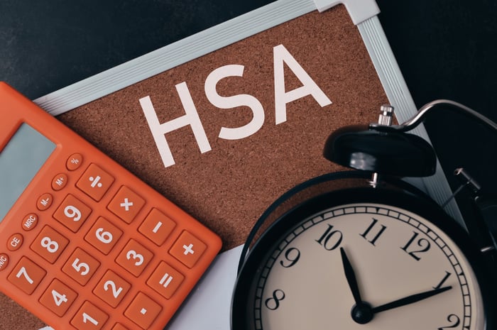 Alarm clock, calculator, and bulletin board displaying the letters H, S, and A.