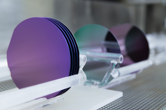 Circular wafers on a production belt. 