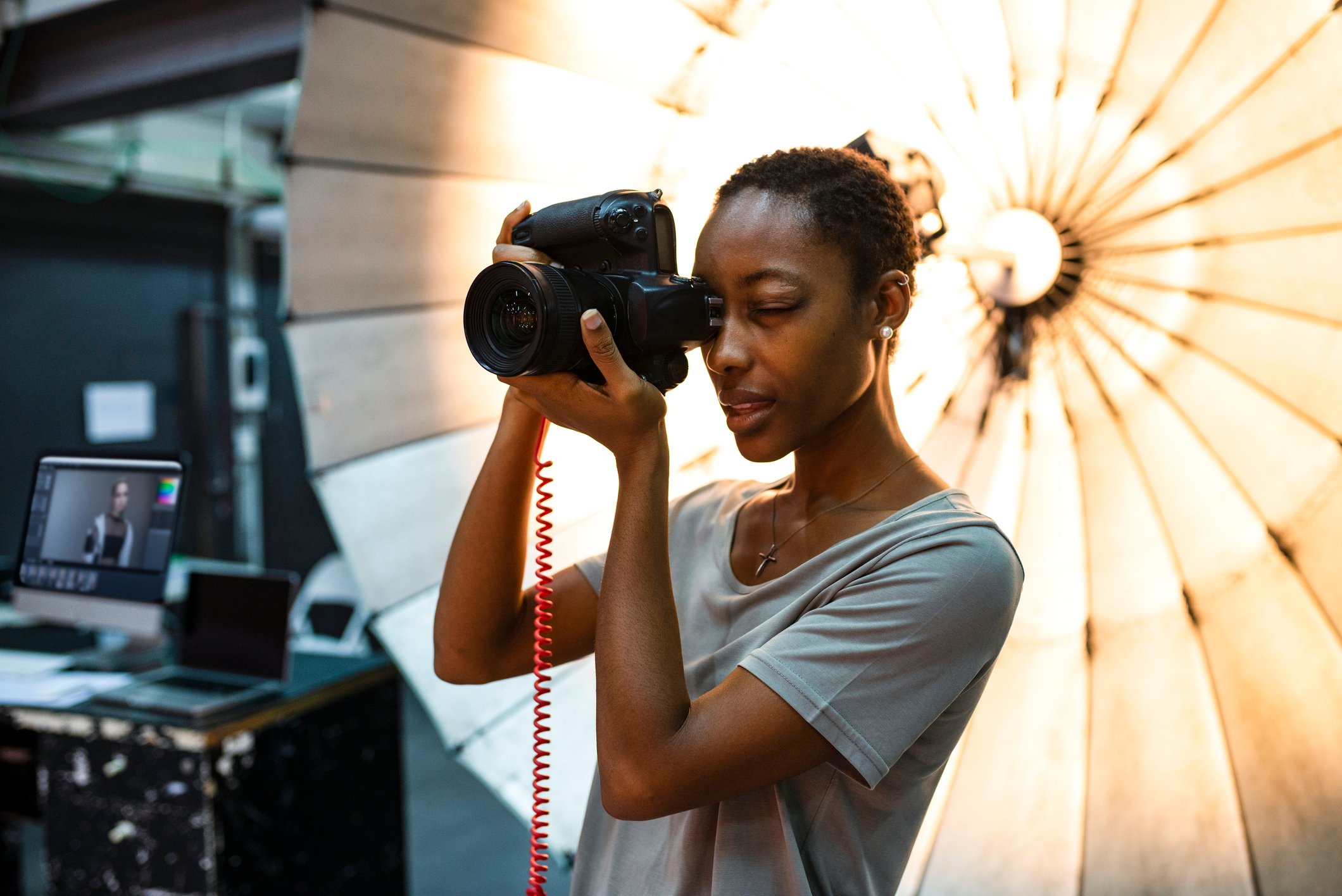 A photographer at work in front of a lighting rig