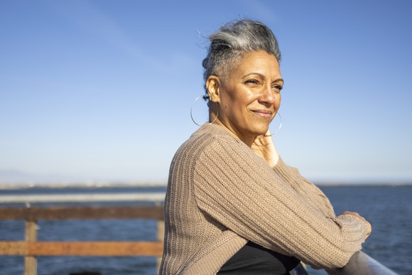 A person relaxes at a pier.
