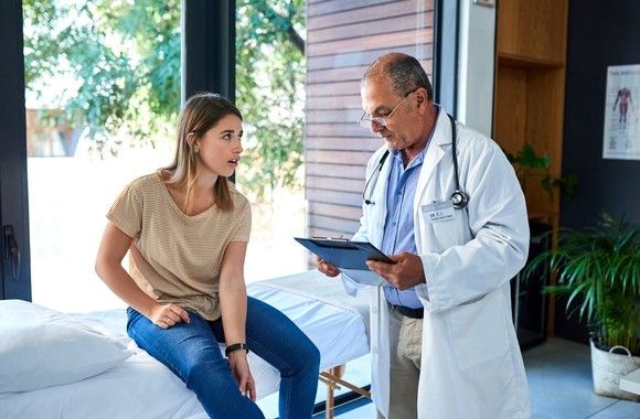 A doctor consults with a patient.