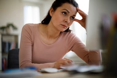 Concerned woman looking at computer