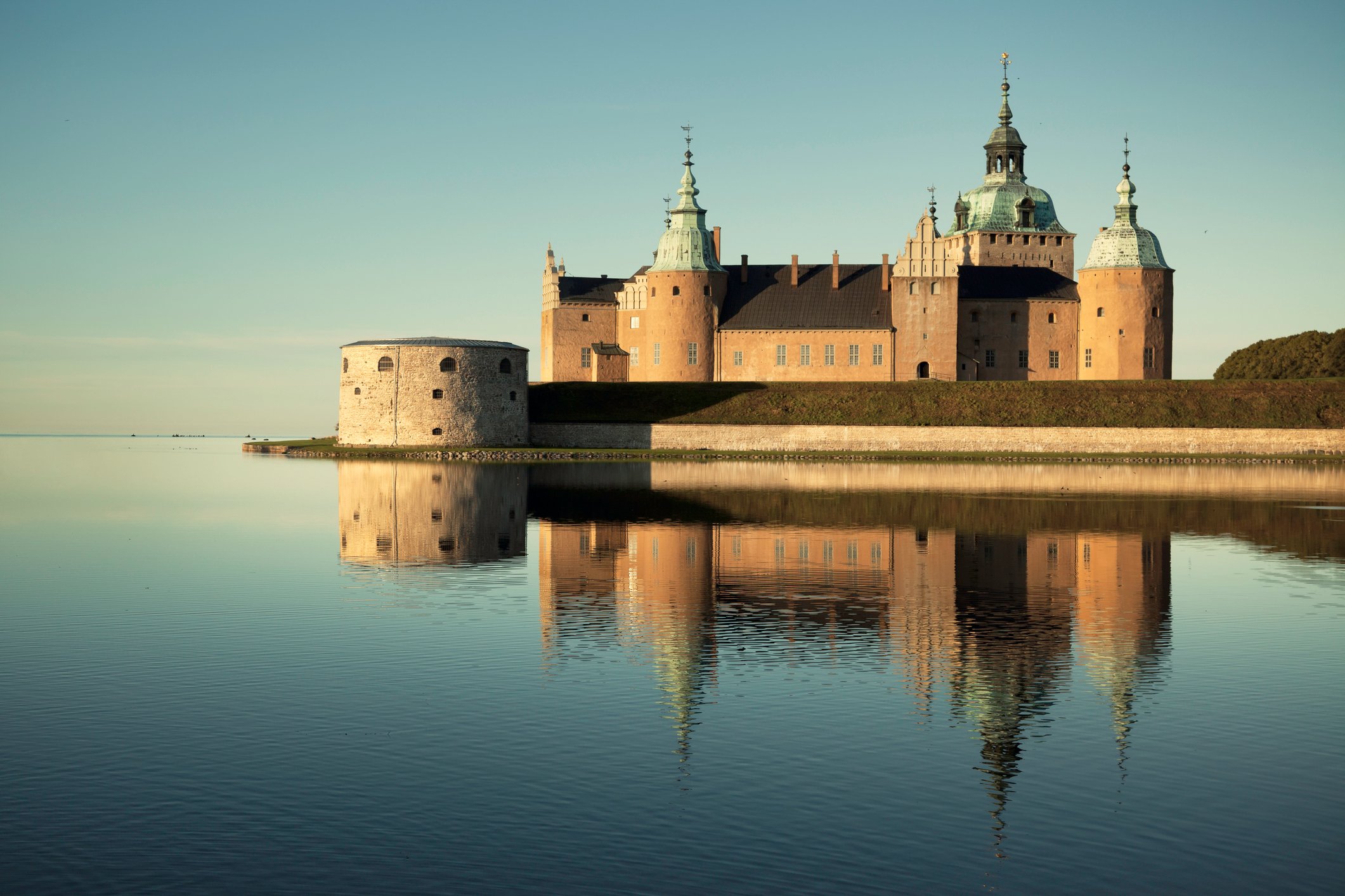 A castle surrounded by a moat. 