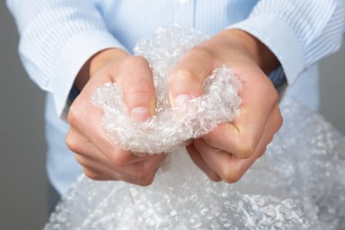 Pair of hands clutching bubble wrap