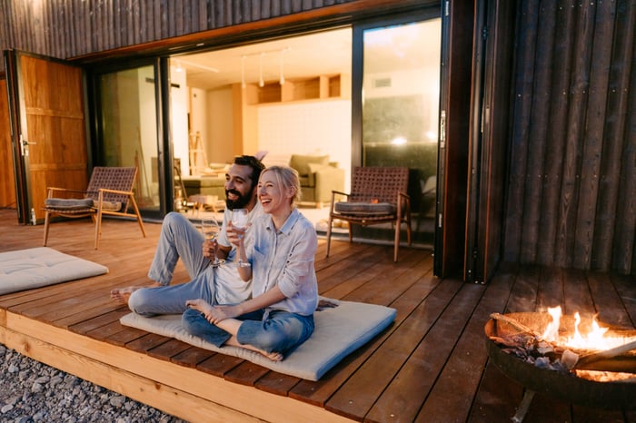 Two people sitting on a patio.