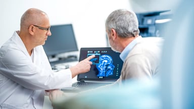 neurologist shows patient a brain scan image