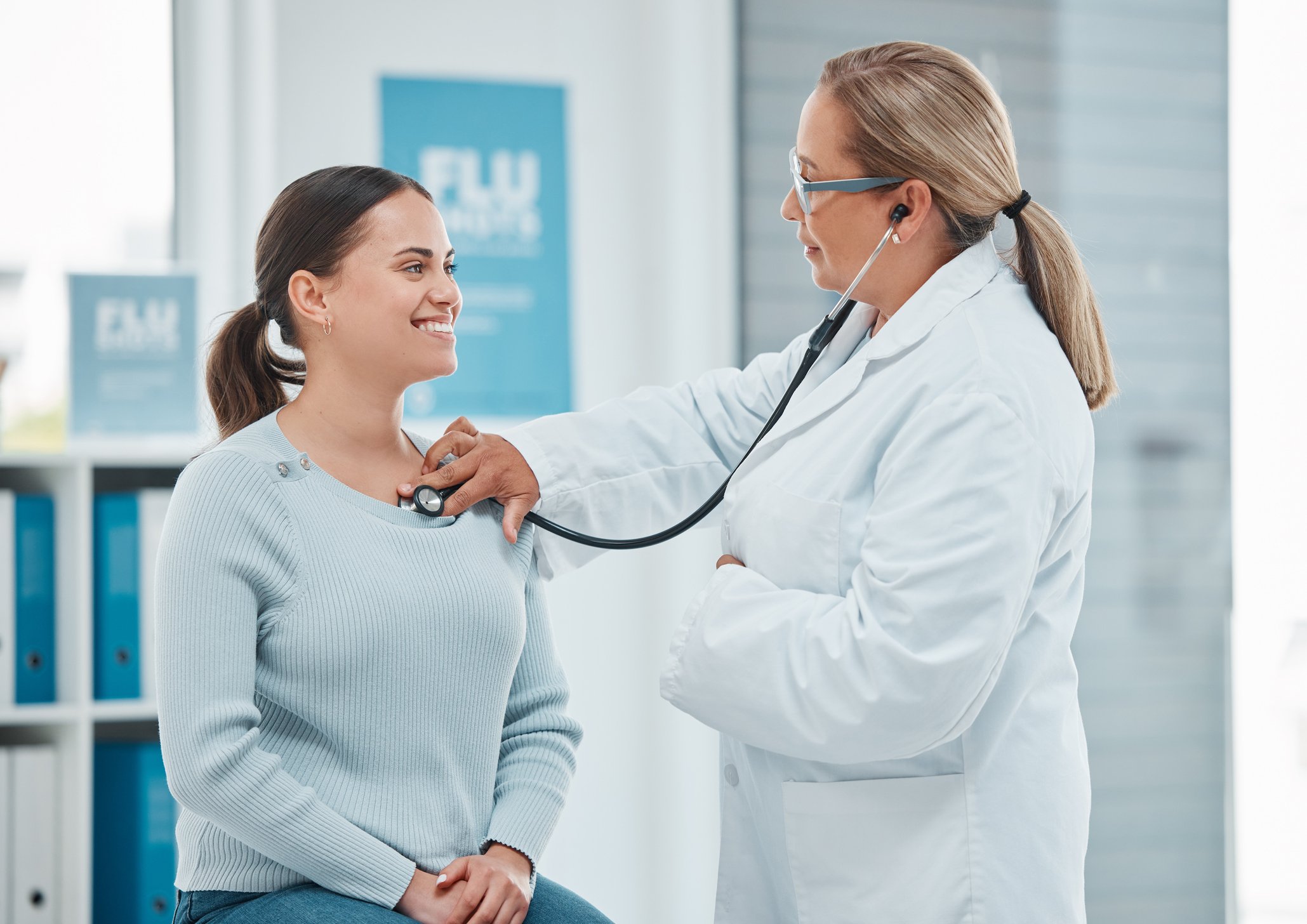 A doctor examines a patient with a stethoscope.