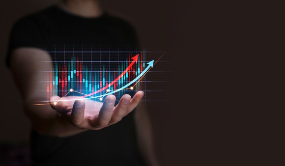 Stock market arrows going up in hand. 