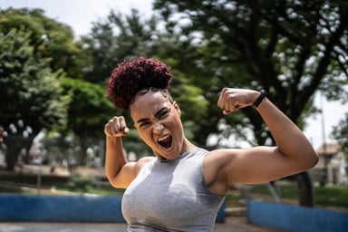 An empowered woman flexes her muscles