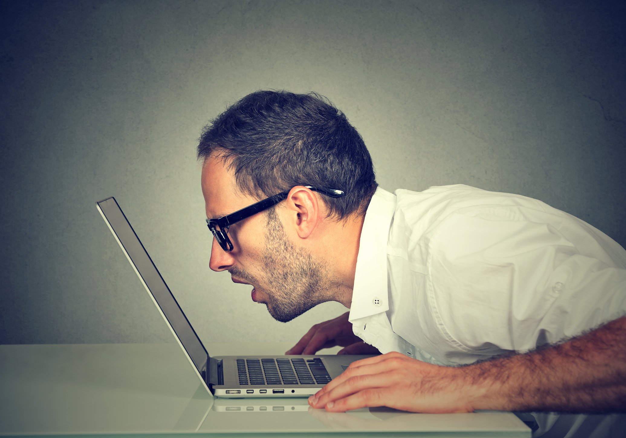 Person looking closely at computer Getty