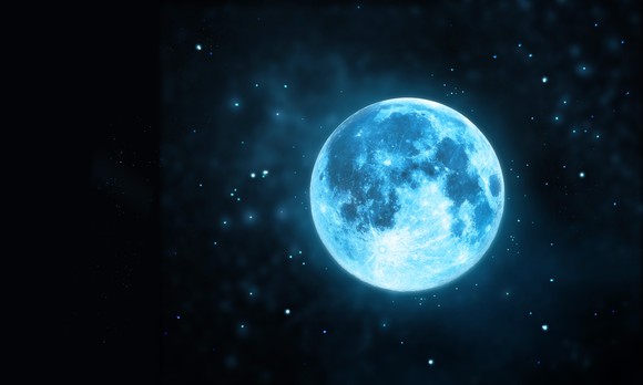 Blue moon shines in a starry sky.