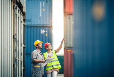 Workers inspect cargo containers.