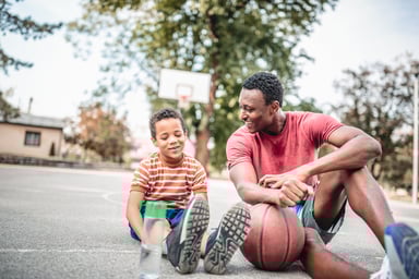 A-kid-looking-at-his-basketball-shoes