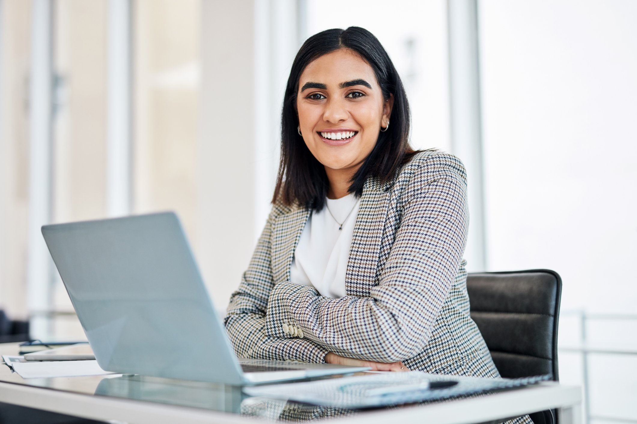 A businessperson works on a laptop.