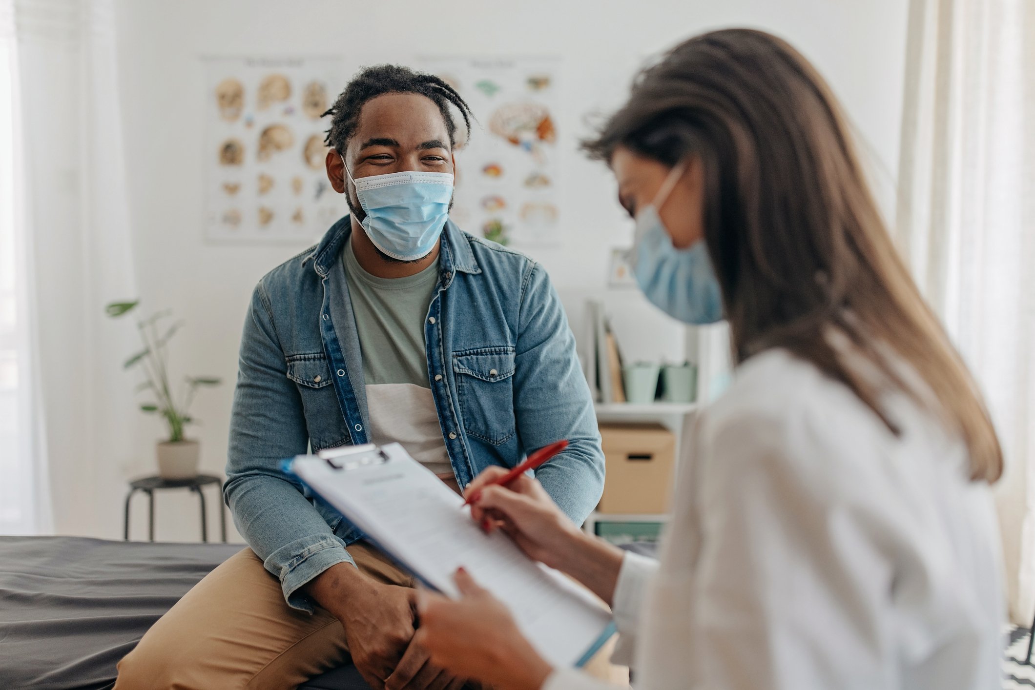 Physician with a patient with masks