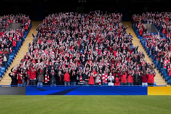A picture of fans in a soccer stadium.
