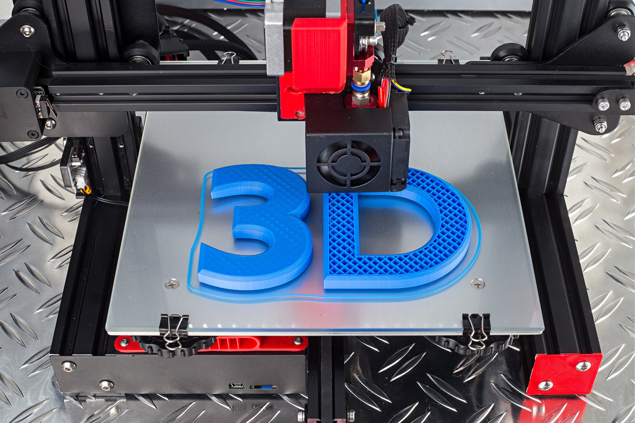 3D printer printing characters 3D in blue plastic