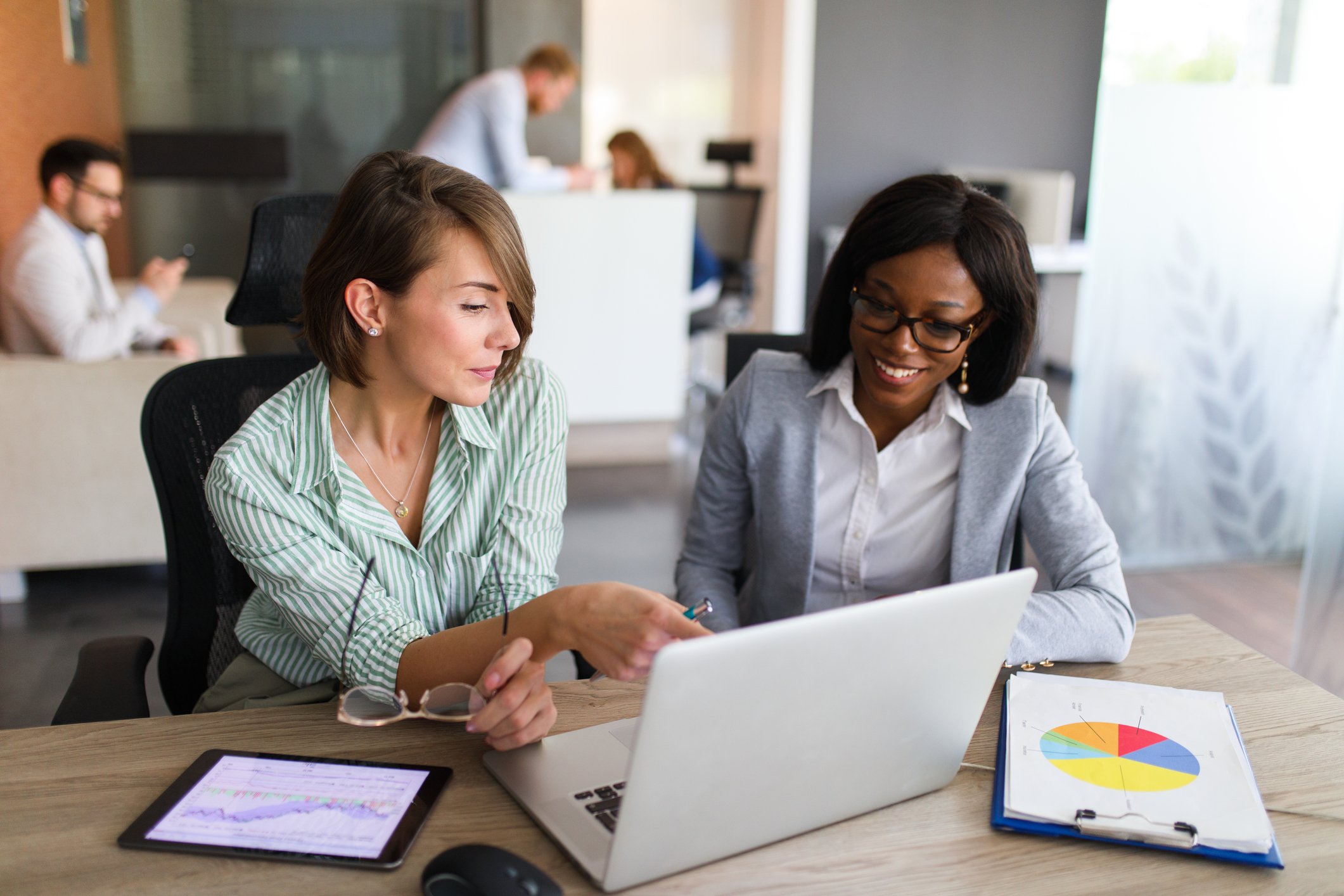 Two people looking at computer screen.