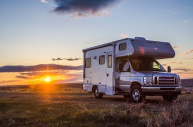 A motor home parked at sunset.