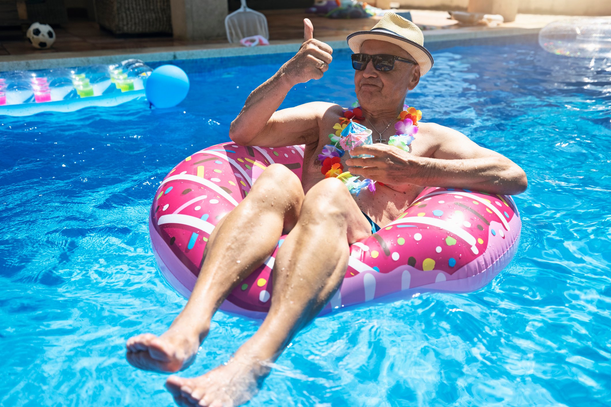 Senior man enjoying retirement in swimming pool (1)