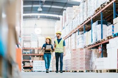 Two employees working at a warehouse.