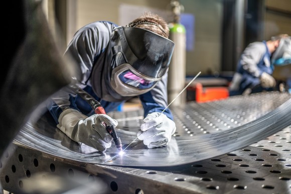 A person welding sheet metal. 