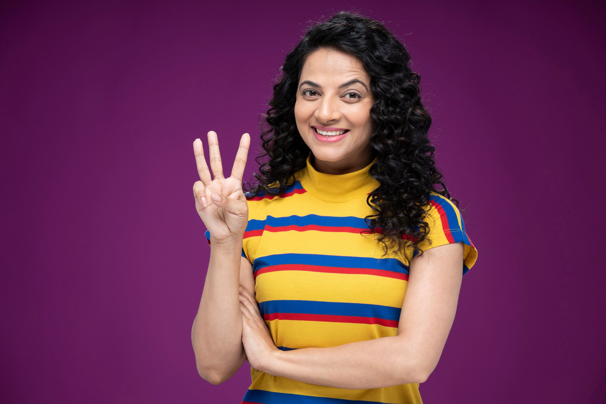Getty - young person three fingers 3 smiling