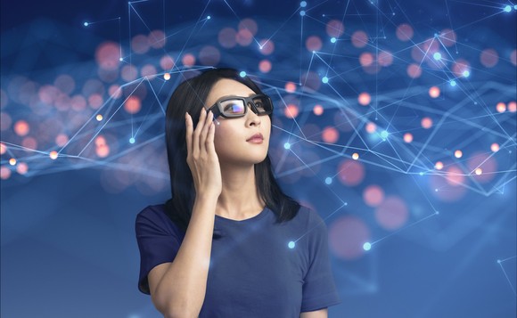 A person wears a pair of Vuzix's AR smart glasses.