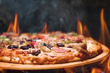 Hot pizza on an open flame.