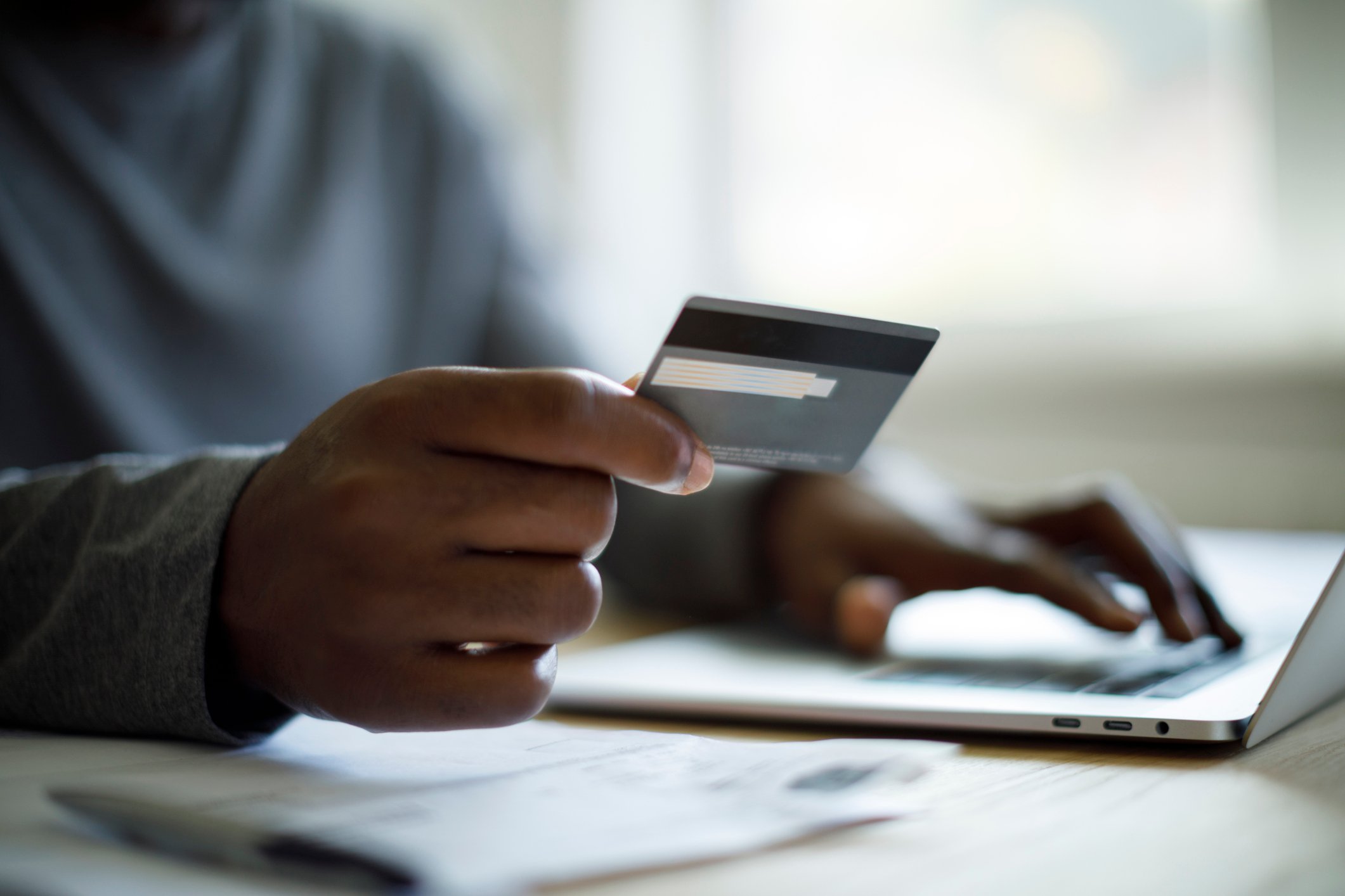 A person holding a credit card.