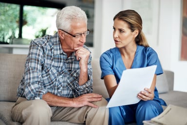 doctor explains paper to patient