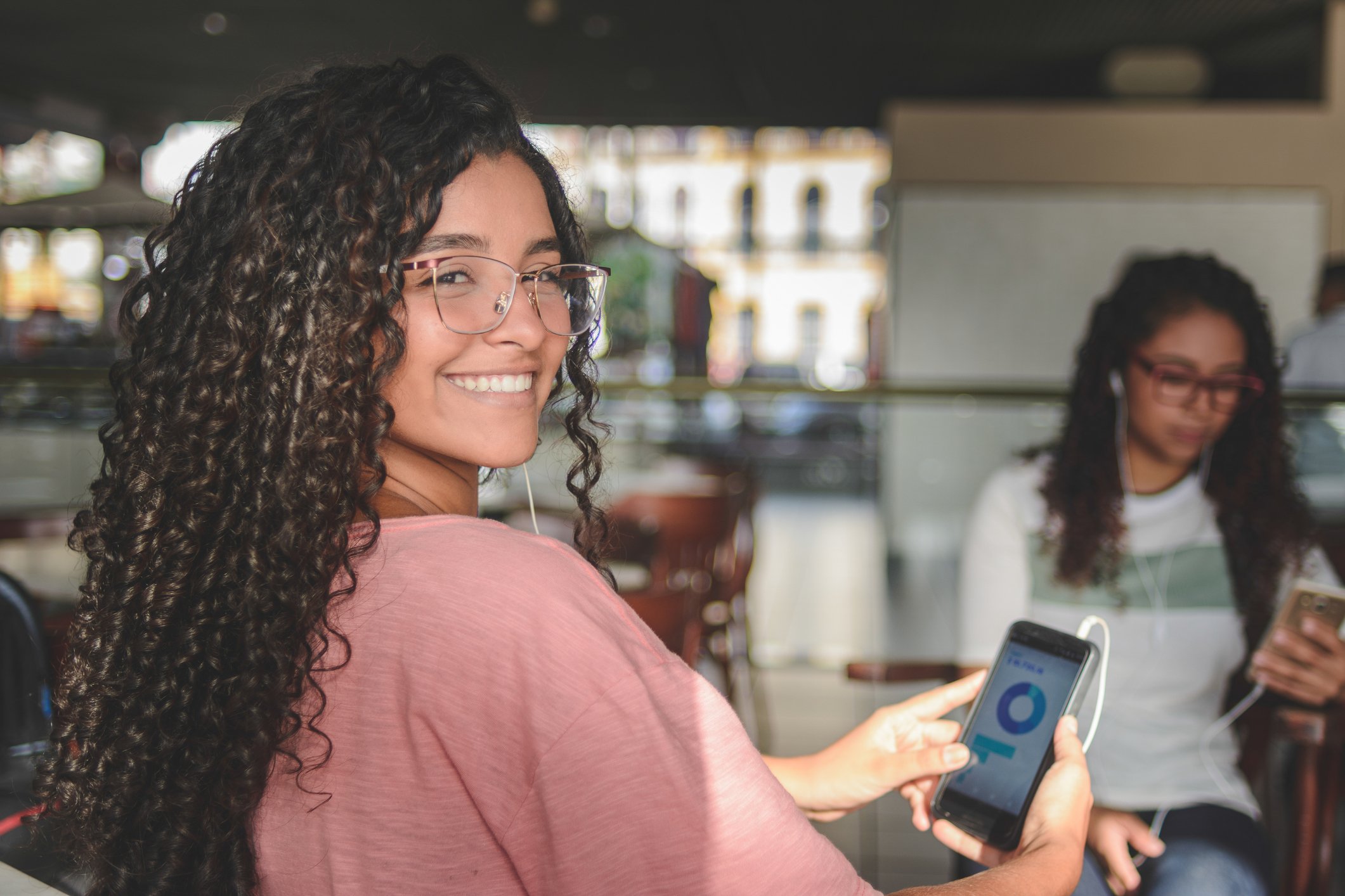 A smiling person checks a portfolio on a smartphone.