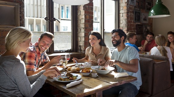 A group of people eating at a restaurant.