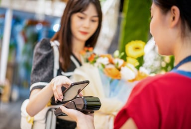 person pays merchant with phone