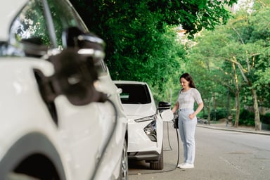 Driver charges an electric vehicle.