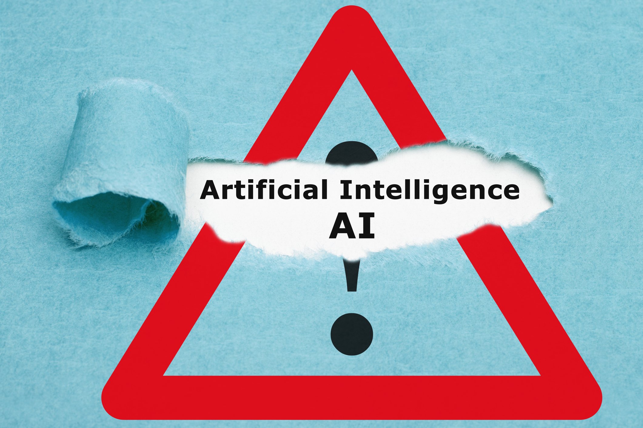 Warning symbol with paper torn to reveal the words Artificial Intelligence AI.