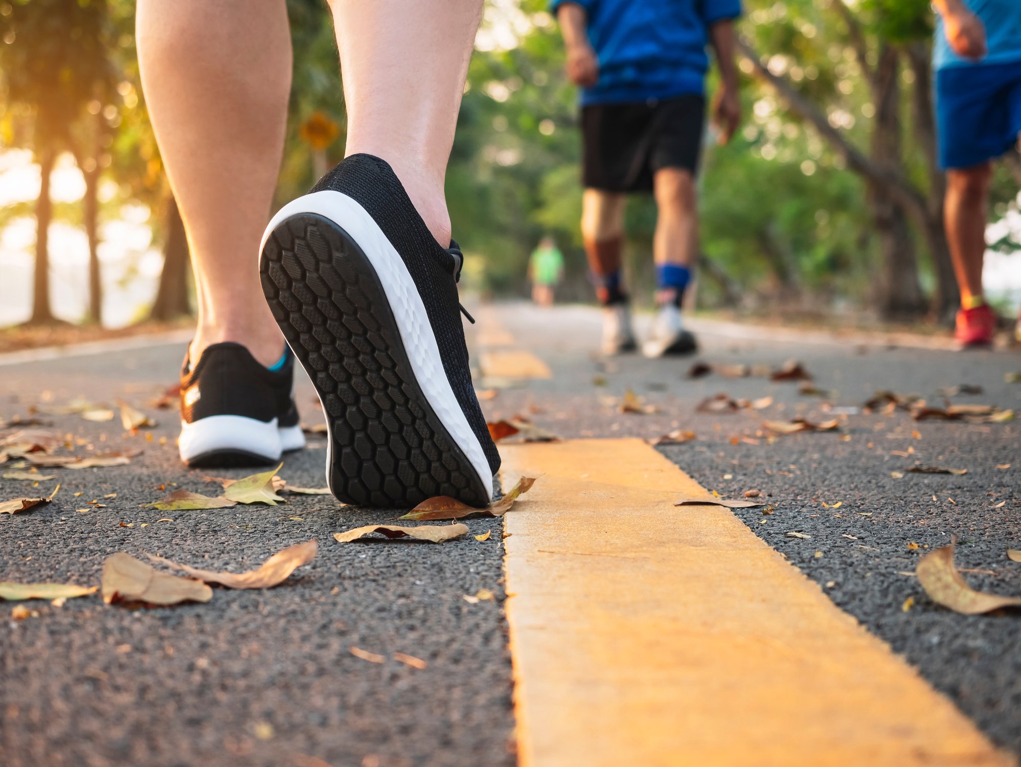 People wearing running shoes on a road.