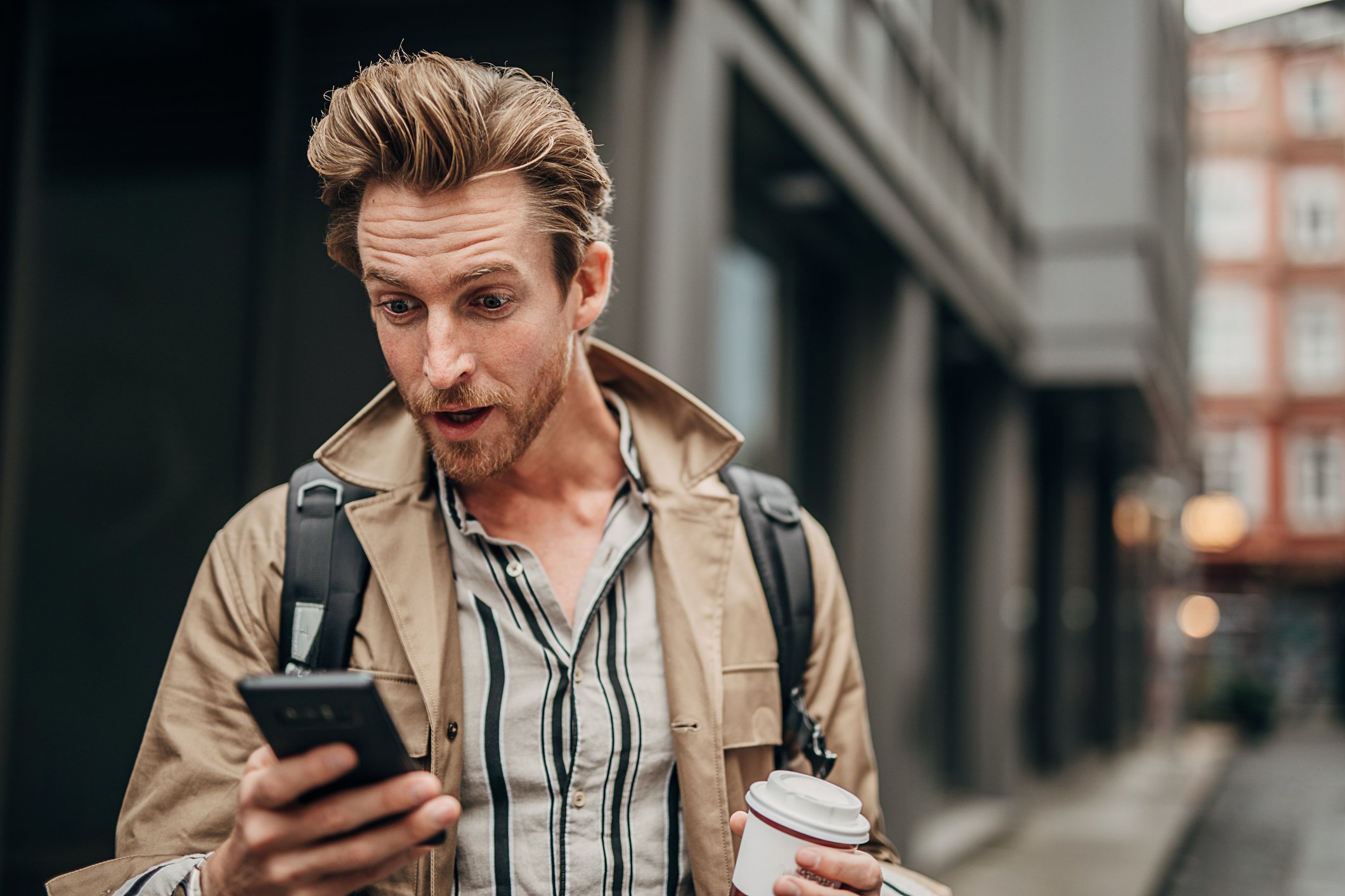 Person looking at phone, happy.