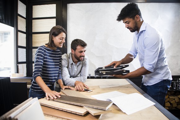 Two people looking at floor tiles.