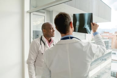 Doctors looking at a leg x-ray.