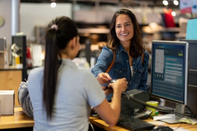 A person paying at a store with a credit card