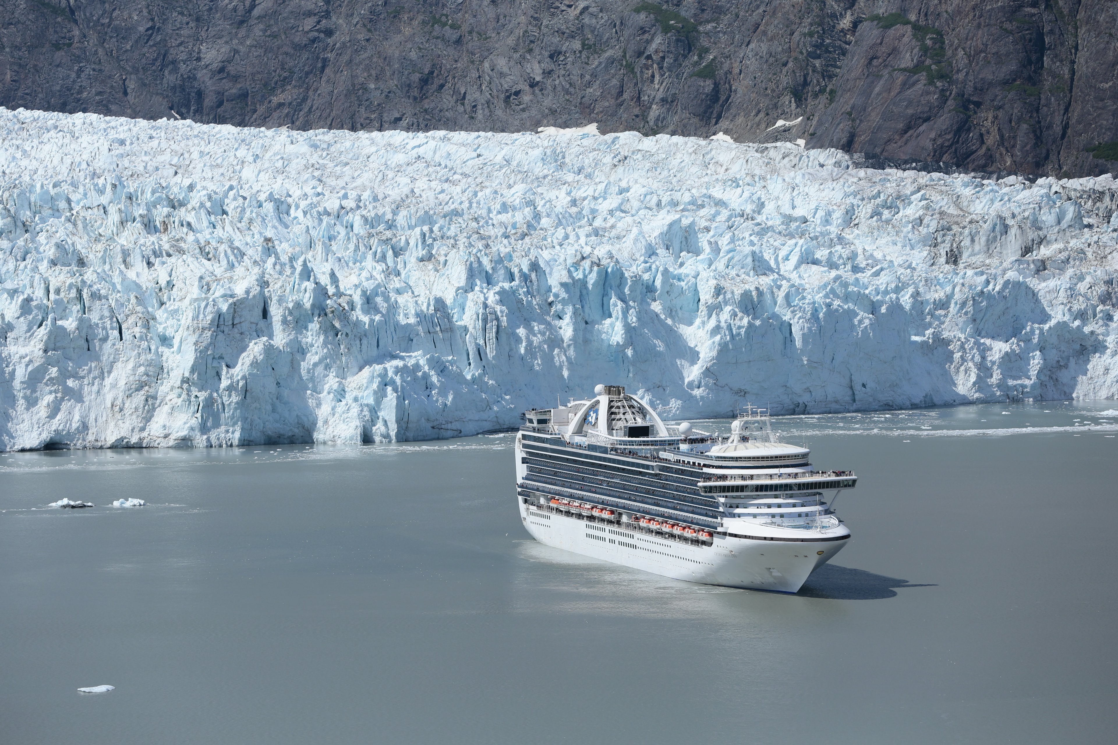 A Carnival cruise ship floats gently through Glacier Bay, Alaska.