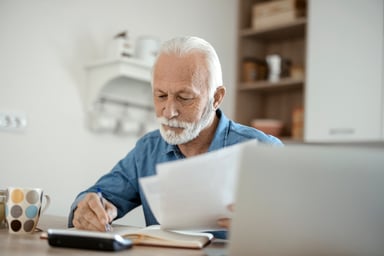 older man at desk serious GettyImages-1367292739