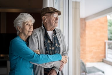 Older couple looking out window