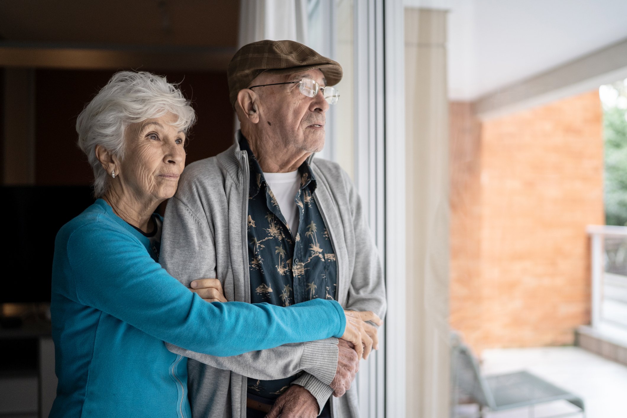 Two people looking out a window.