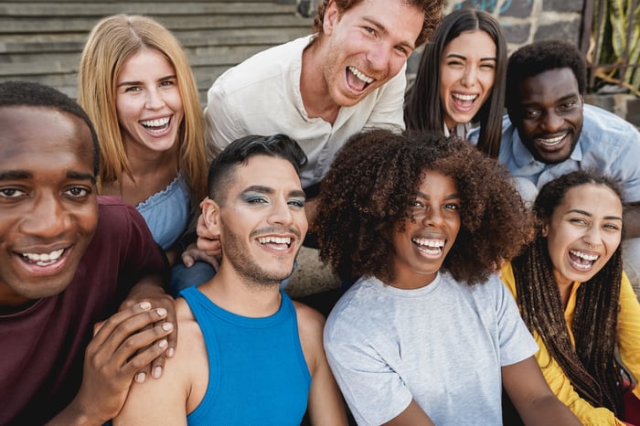 A group of eight young people, smiling.