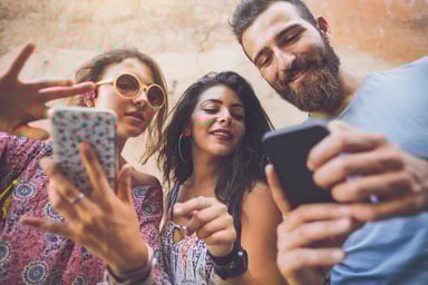 three friends with smartphones