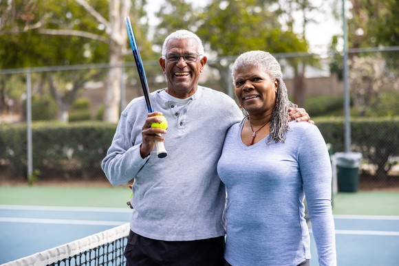 A couple enjoys a game of tennis.